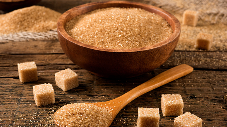 wooden bowl and spoon full of brown sugar