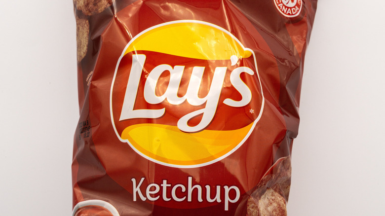 Bag of Lay's ketchup chips on white background