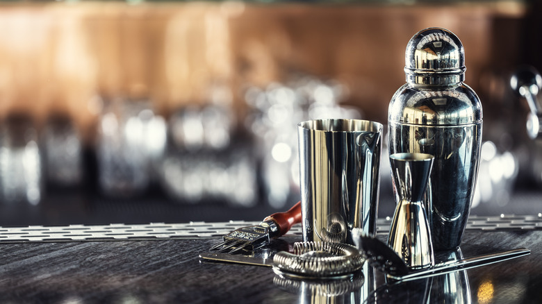 cocktail shaker and other bar tools on bar
