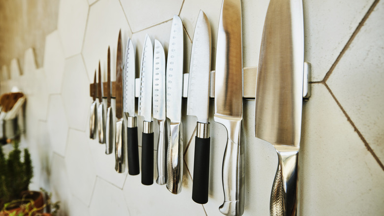 kitchen knives arranged along a wall