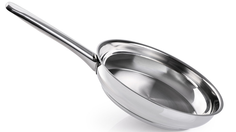 stainless steel frying pan on white background