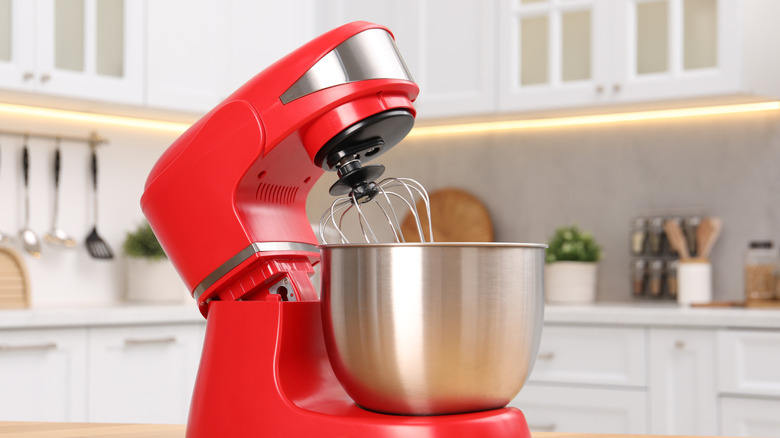 red stand mixer sitting on counter