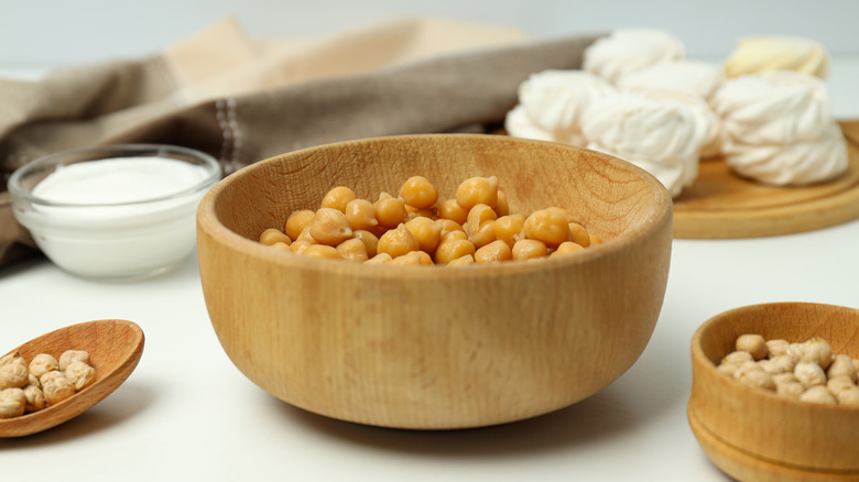 chickpeas in bowl surrounded by vegan meringues