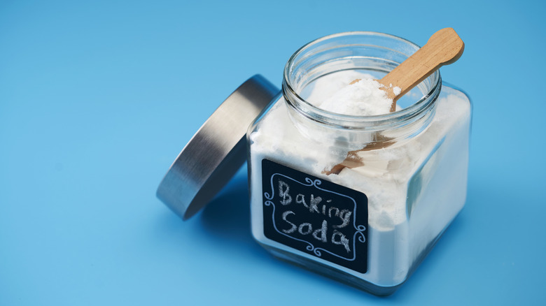 baking soda jar with hand written label on blue background