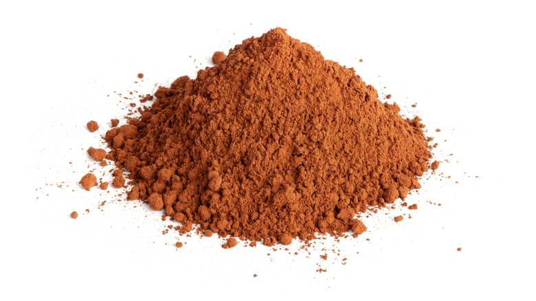 cocoa powder pile on white background
