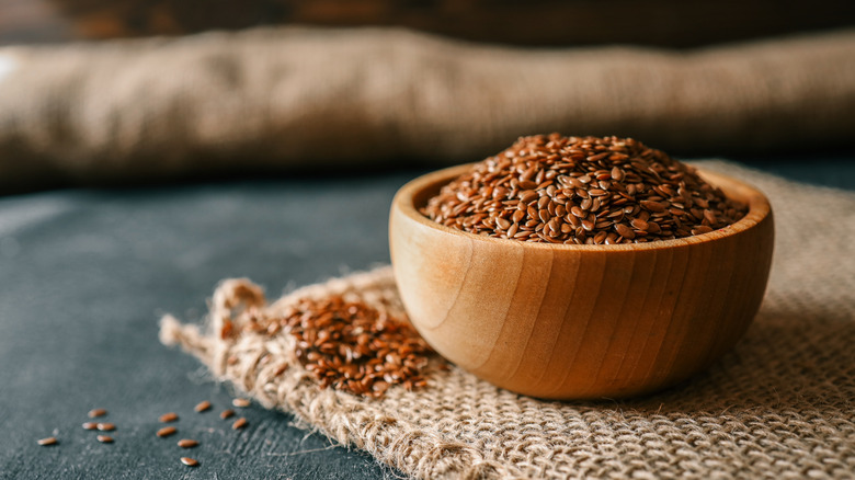 flaxseeds in wooden bowl on burlap