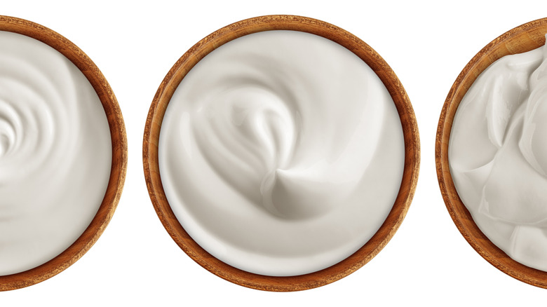sour cream and cream cheese in wooden bowls