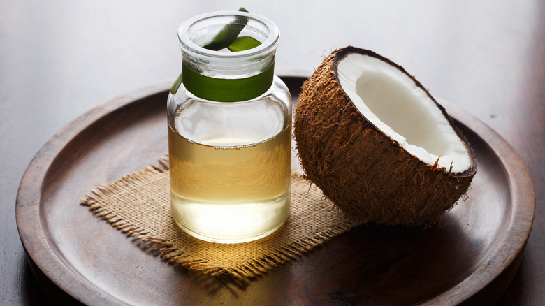 coconut oil and coconut half sitting on tray