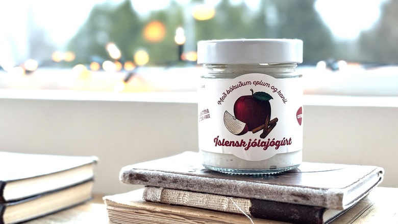 Christmas yogurt in glass jar stacked on books