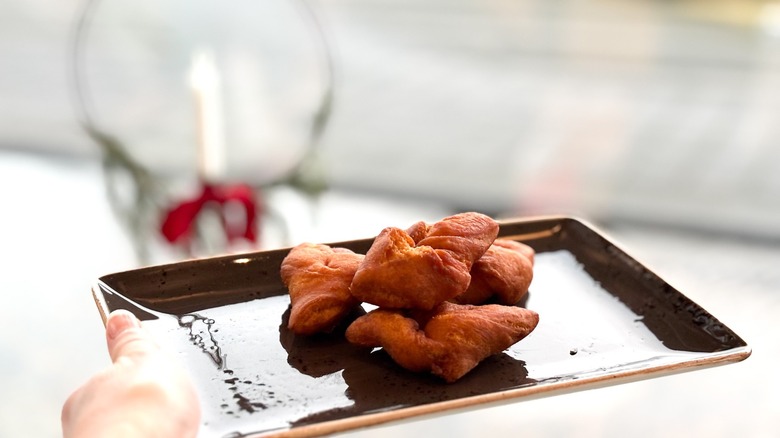 small kleinur donuts or angel wings on black tray