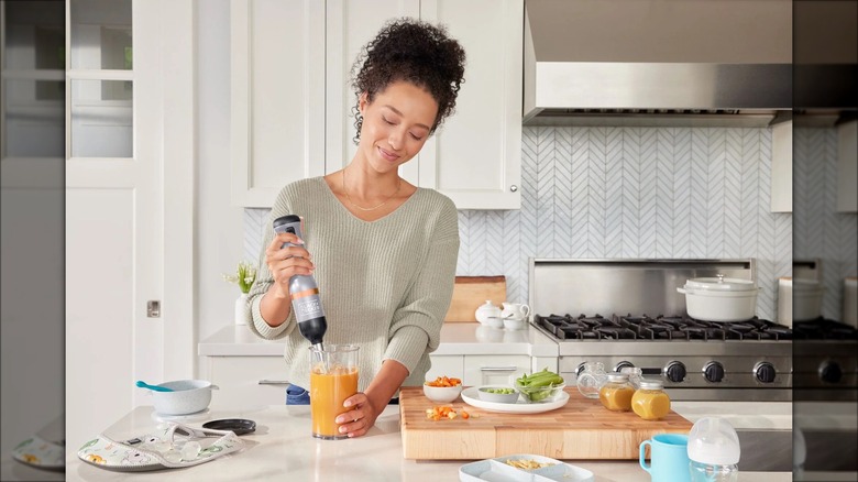 Person making soup with immersion blender