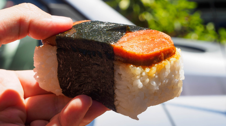 Person holding spam musubi