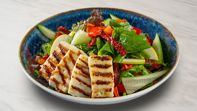 grilled halloumi slices on bed of salad