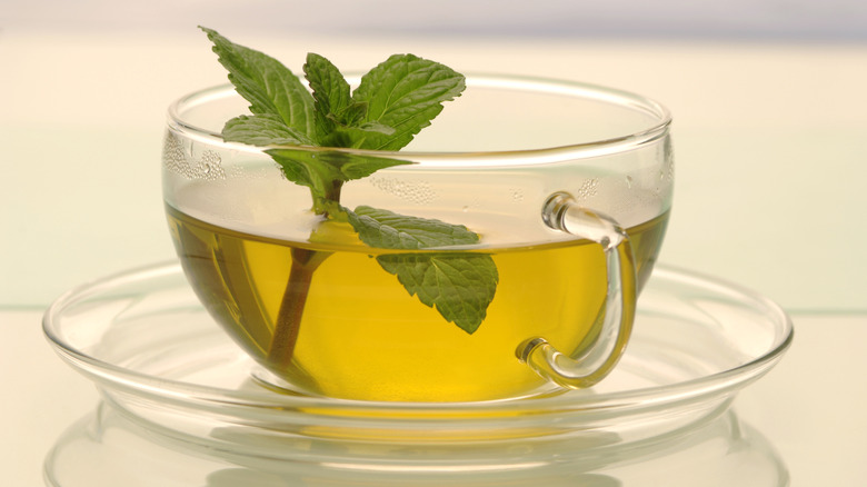 small glass teacup of mint tea with mint leaves