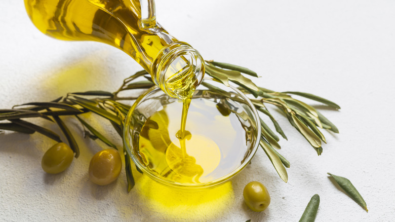 olive oil pouring into a small glass bowl