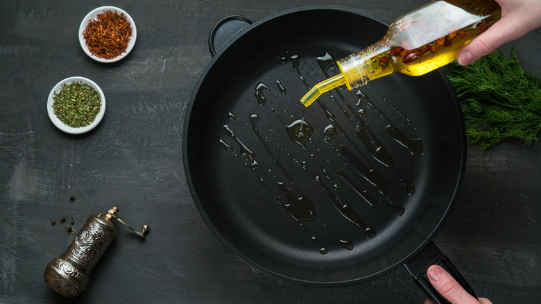 pouring oil on pan