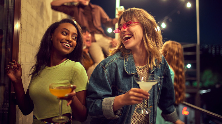 women laughing with drinks