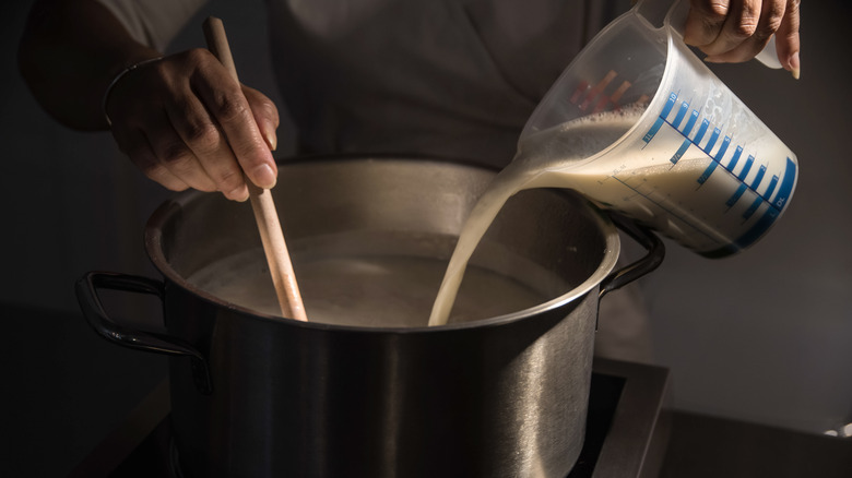 Stirring milk in pot