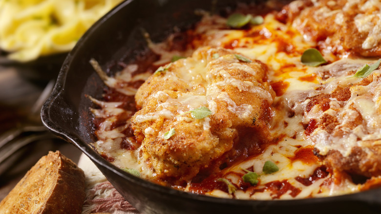 Skillet chicken parmesan is shown in closeup.