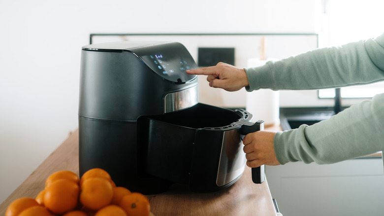 Person using air fryer