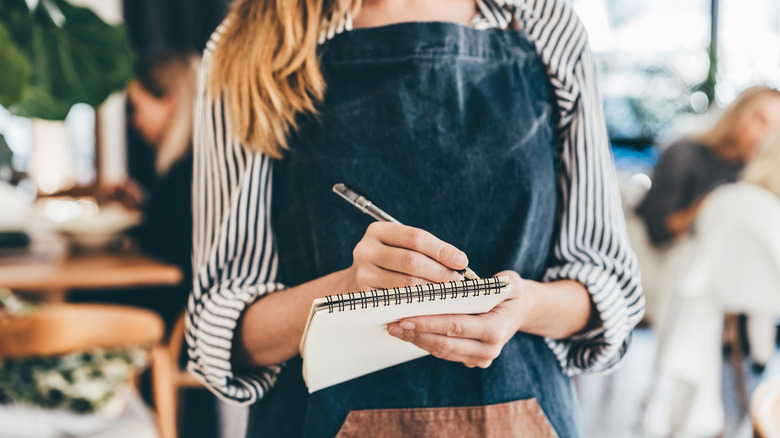 waitress writing on notepad