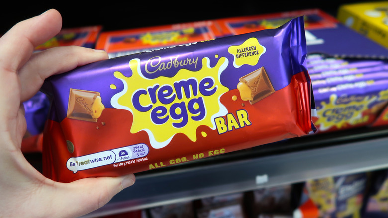 A person holding a Cadbury creme egg bar