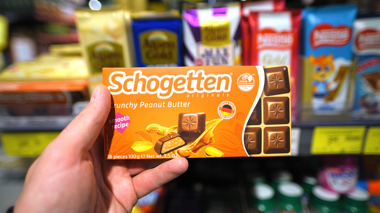 A person holding a Schogetten chocolate bar