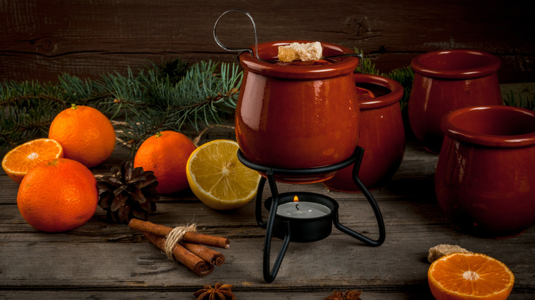 A mug of Feuerzangenbowle mulled wine from Germany is being heated.