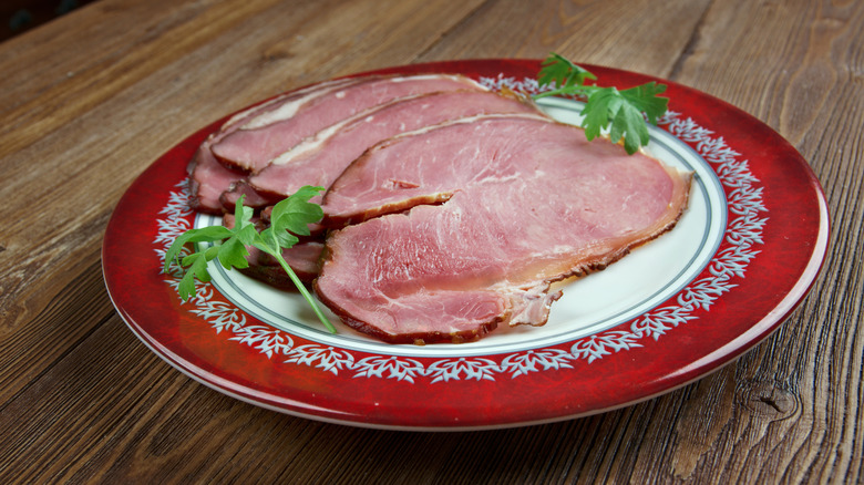 A plate of hangikjöt dried meat from Iceland sits on a plate.