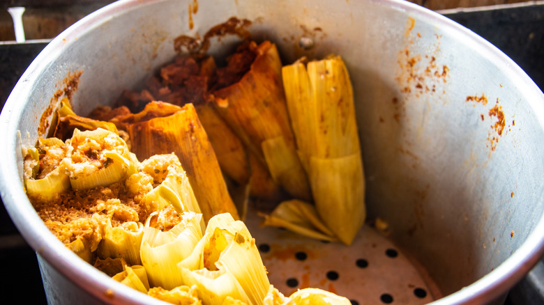 Tamales cook in a pot