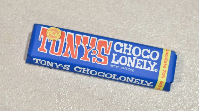 A bar of Tony's Chocolonely dark chocolate on a white counter