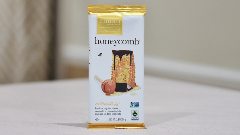 A bar of Chuao honeycomb chocolate on a white counter