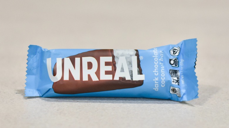 An Unreal coconut chocolate bar on a white counter