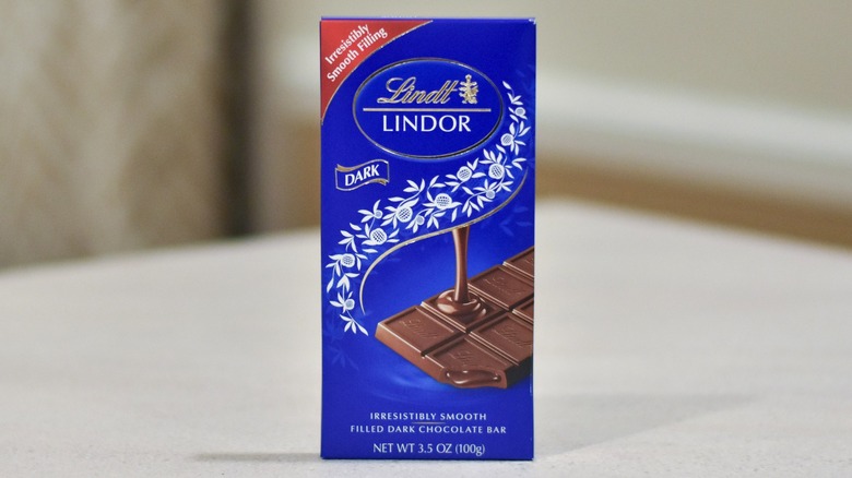 A bar of Lindor dark chocolate on a white counter