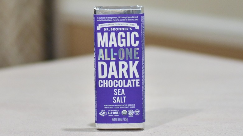 A bar of Dr. Bronner's dark chocolate with sea salt on a white counter