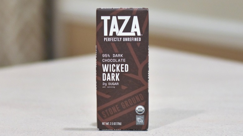 A wrapped bar of Taza chocolate on a white countertop