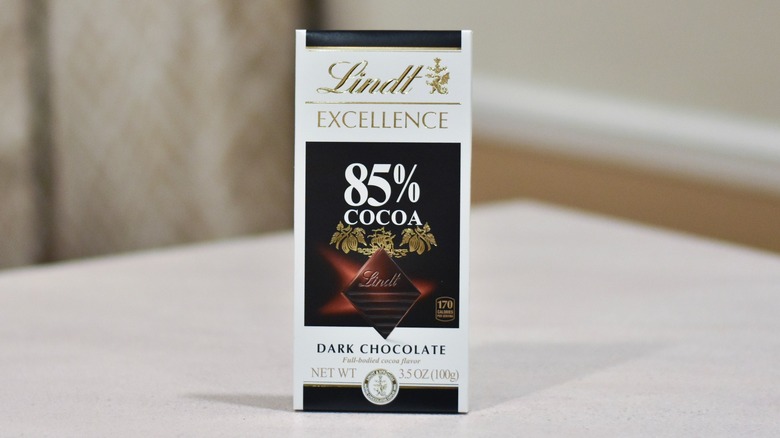 A bar of Lindt Excellence dark chocolate on a white counter