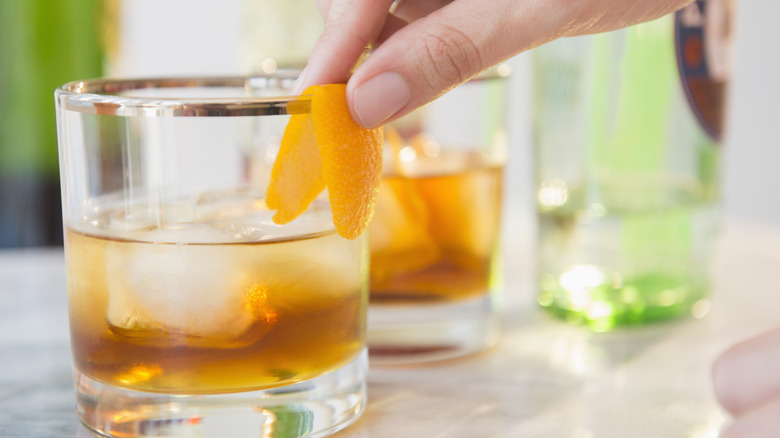 orange garnish placed on a glass