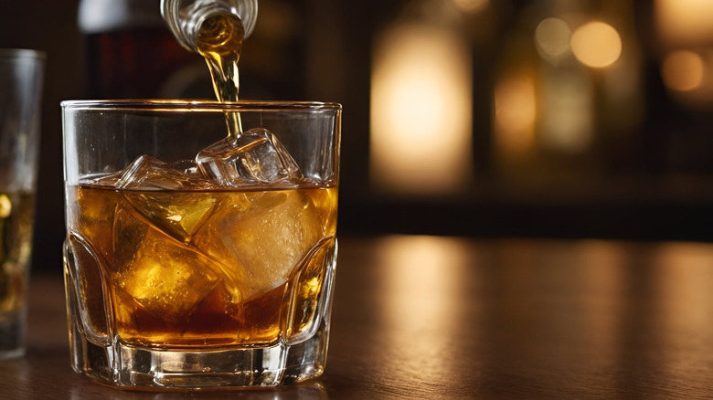 whiskey being poured into a glass