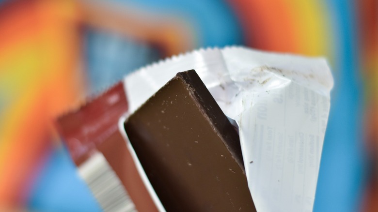 A open chocolate bar in a wrapper in front of an Aldi bag