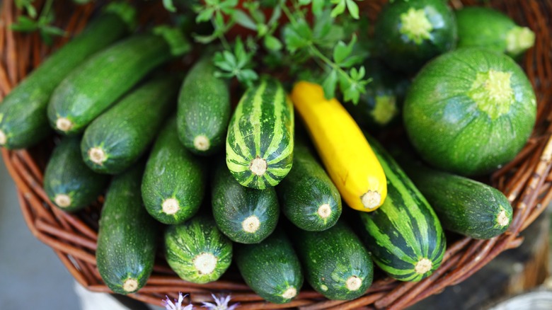 A basket full of green zucchinis