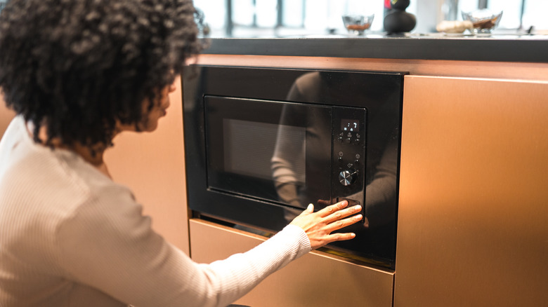 Woman operating the microwave