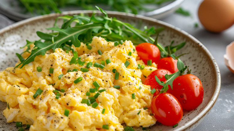 scrambled eggs and tomatoes on the vine