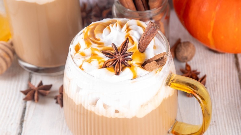 Pumpkin spice latte with cinnamon sticks and caramel syrup