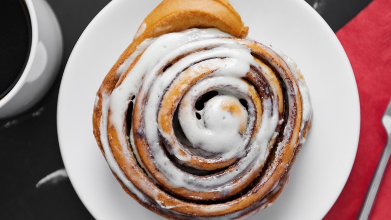 A giant cinnamon roll and a cup of coffee