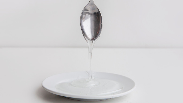 Spoon pouring light corn syrup