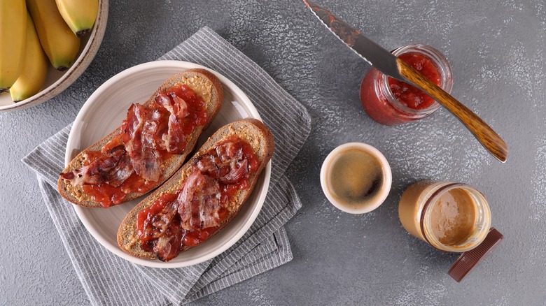 Making a peanut butter, jelly, bacon sandwich