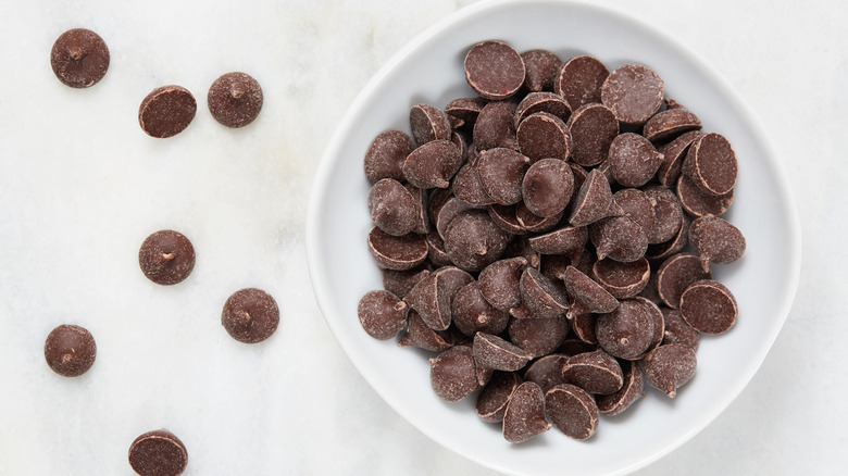 Bowl of chocolate chips on a white background