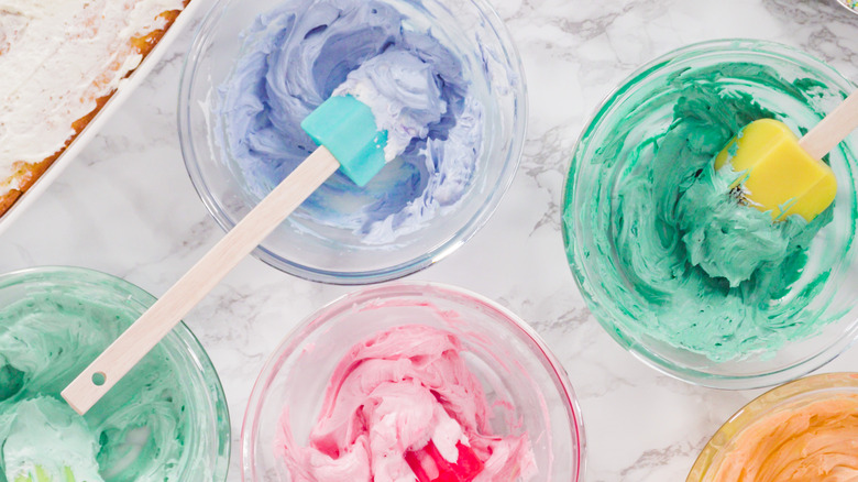 bowls of multi-colored frosting