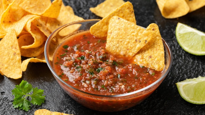 Red salsa with lime and tortilla chips